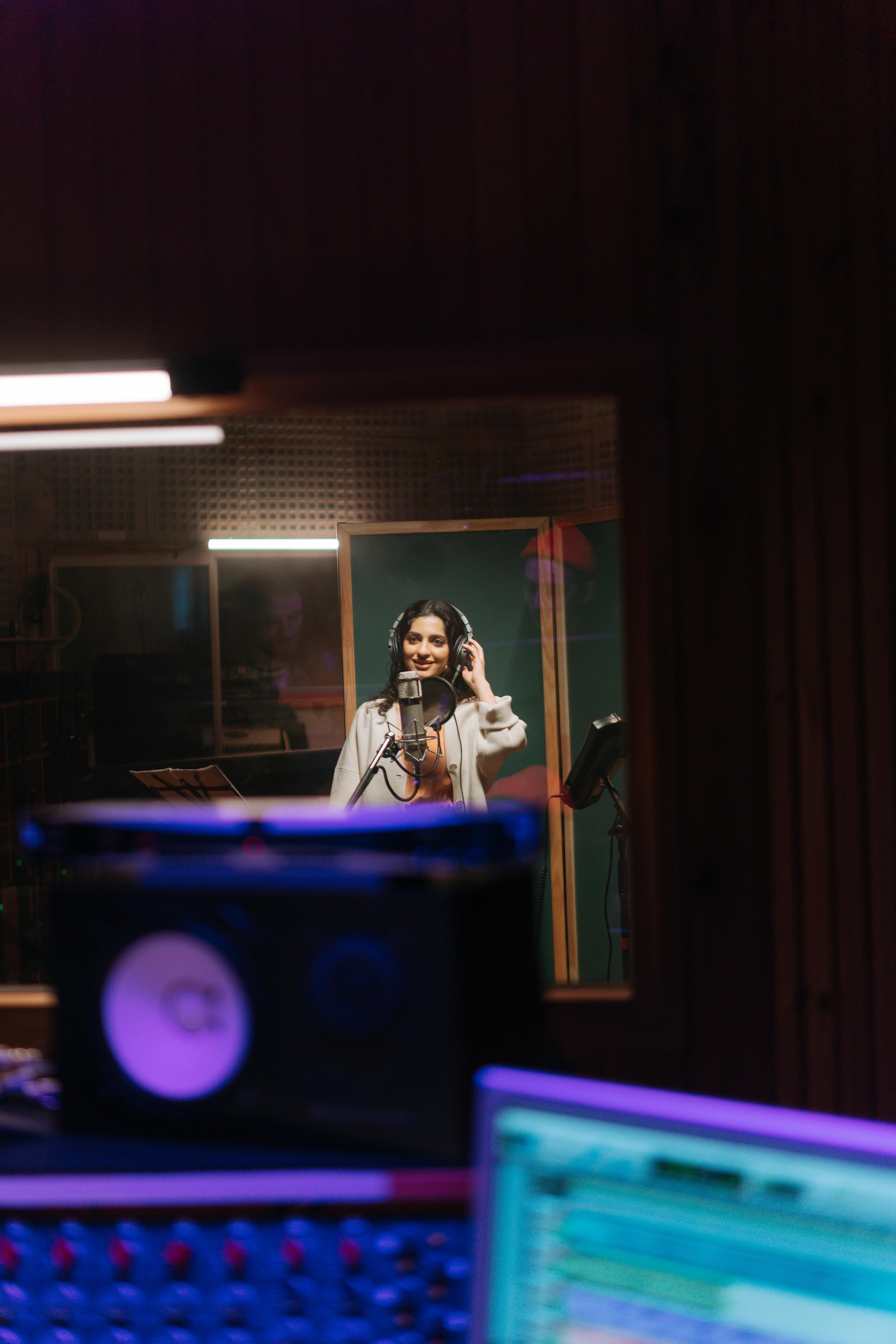 An artist in a studio, thoughtfully considering different vocal styles.